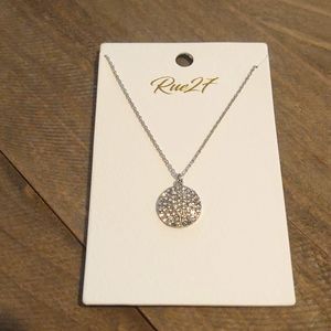 Crystal pave round shaped pendant delicate rhodium necklace.